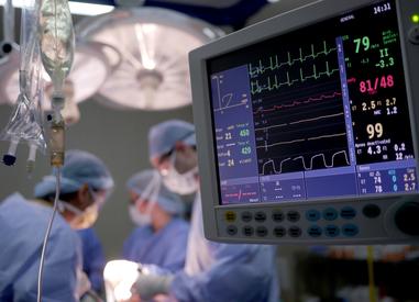 Medical monitoring display showing vital signs and cardiac waveforms